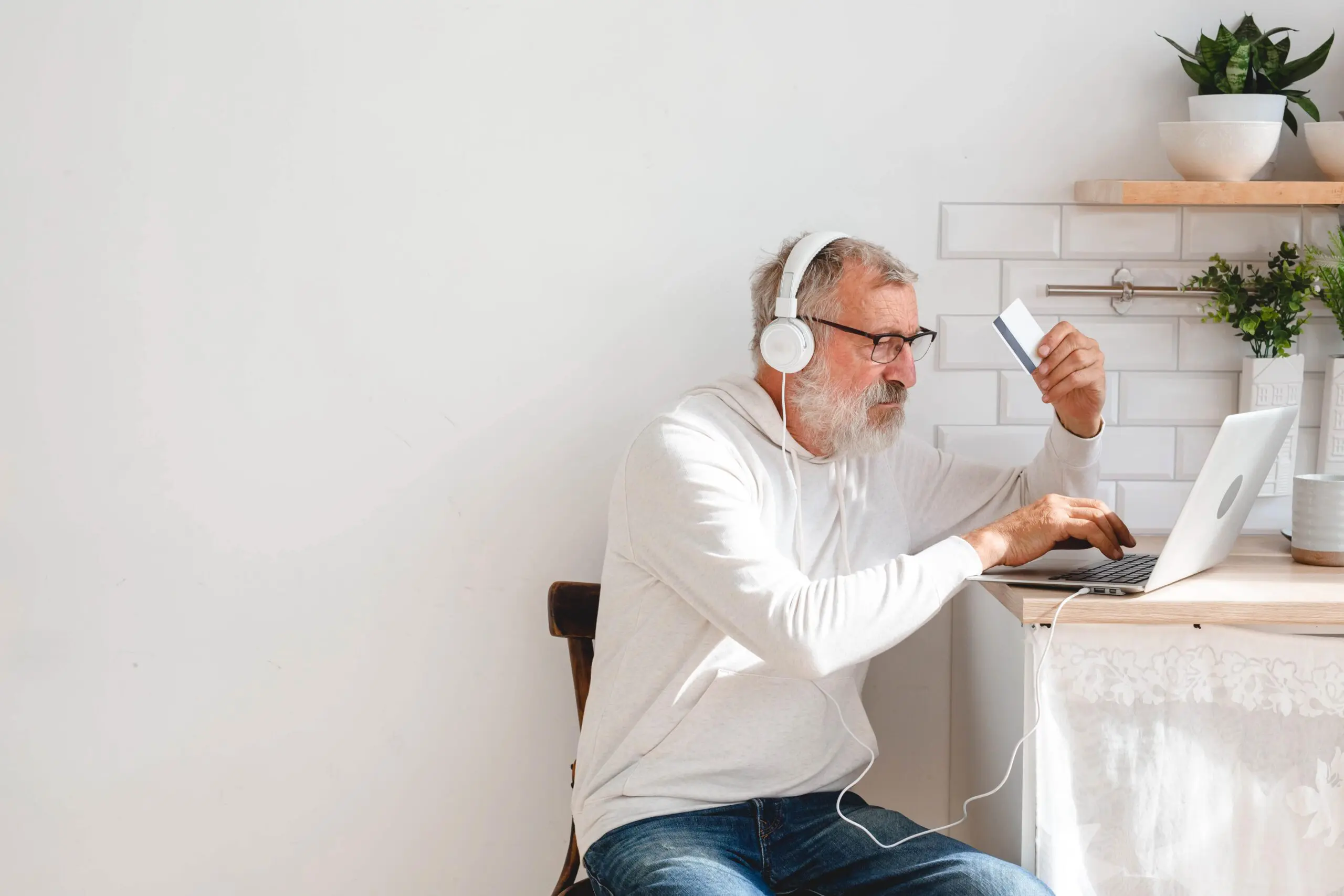 senior-elderly-man-making-online-payments-using-la-2023-11-27-04-52-43-utc-min