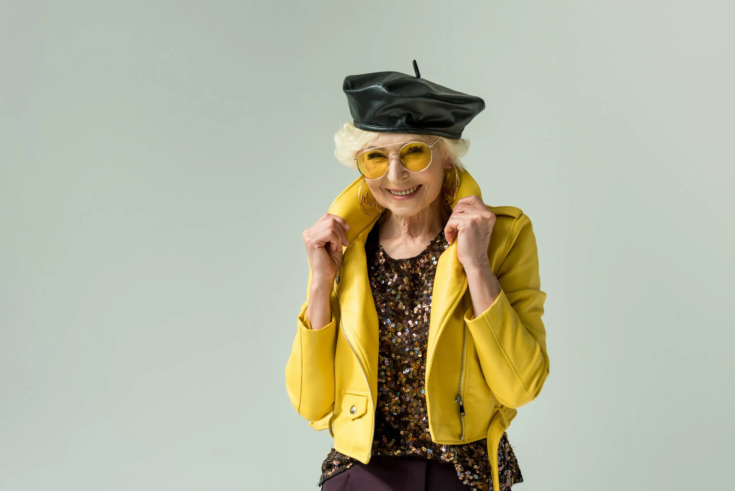 stylish-senior-lady-posing-in-yellow-jacket-and-le-2023-11-27-05-27-53-utc-min