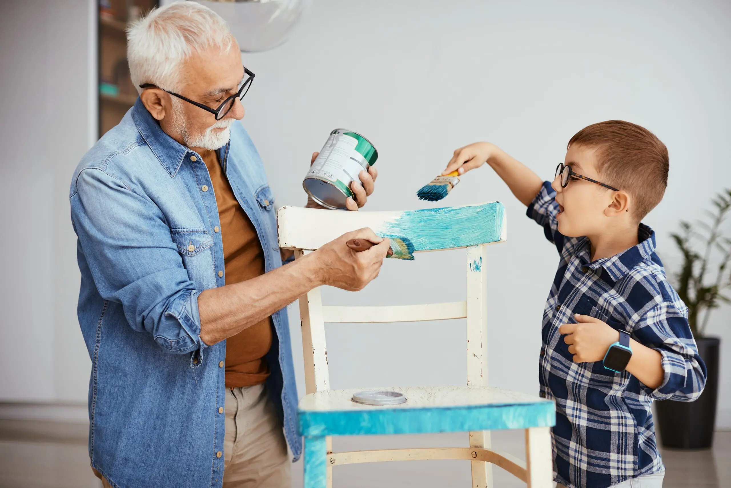 grandfather-and-grandson-painting-chair-in-blue-co-2023-11-27-05-05-59-utc-min